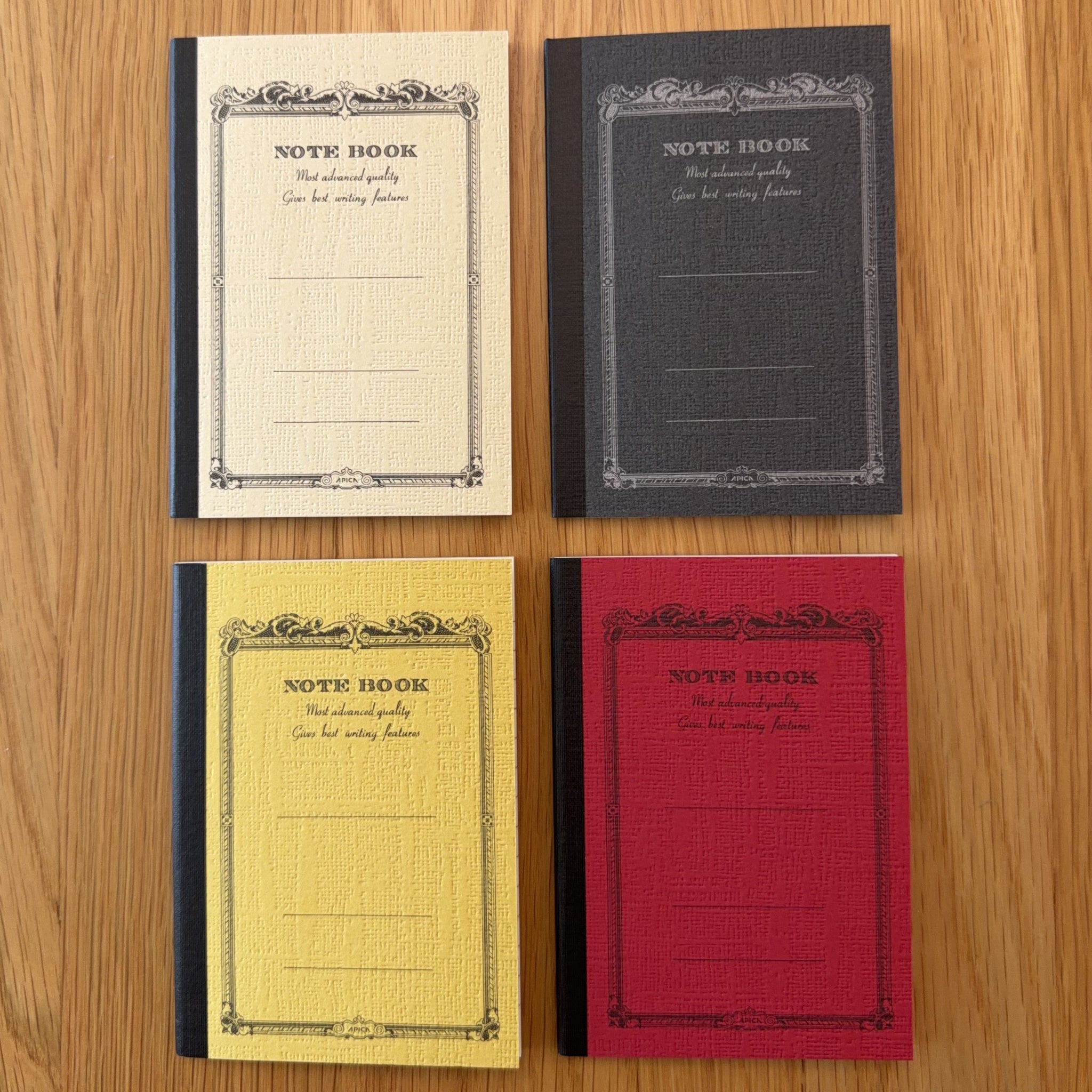 Four Apica CD Notebook A7 colors (Yellow, Black, Mustard, and Red) shown together
