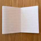 Apica CD Notebook A7 open to show the lined interior pages