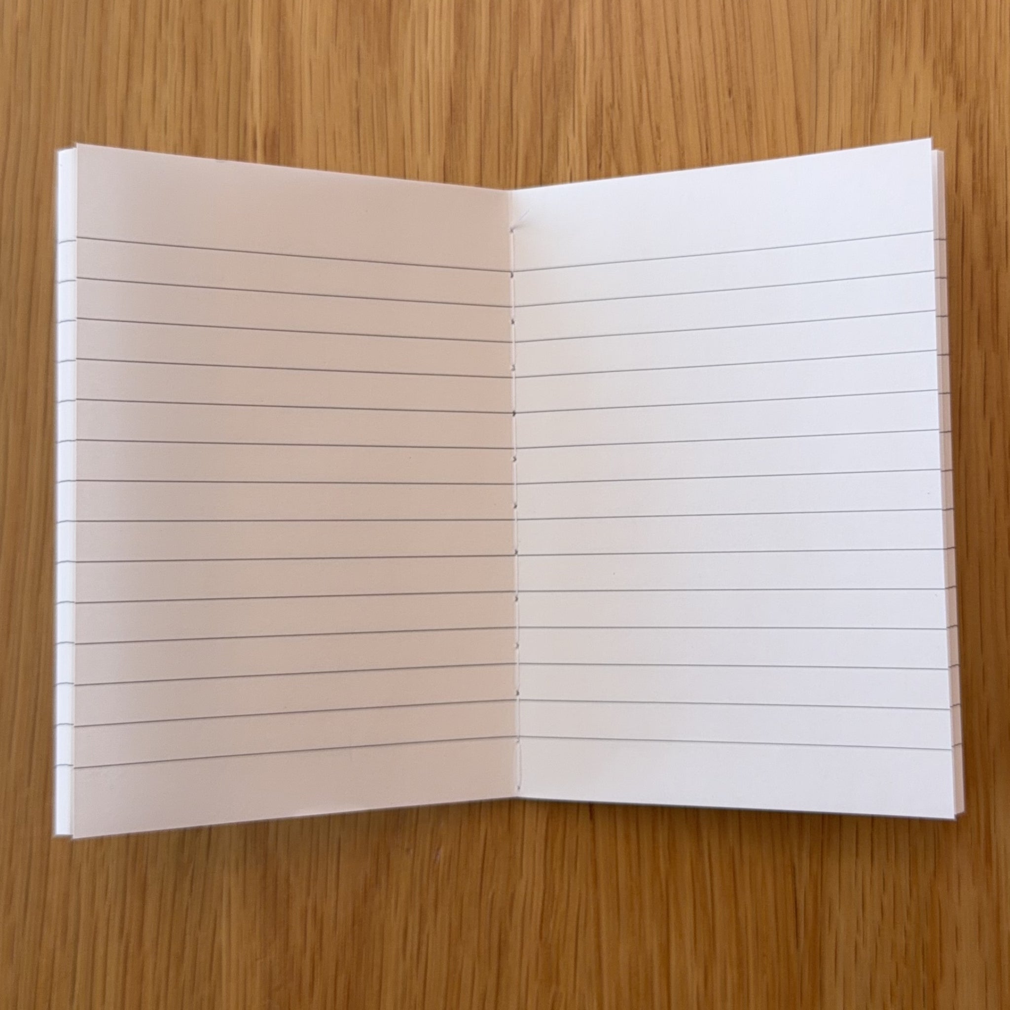 Apica CD Notebook A7 open to show the lined interior pages