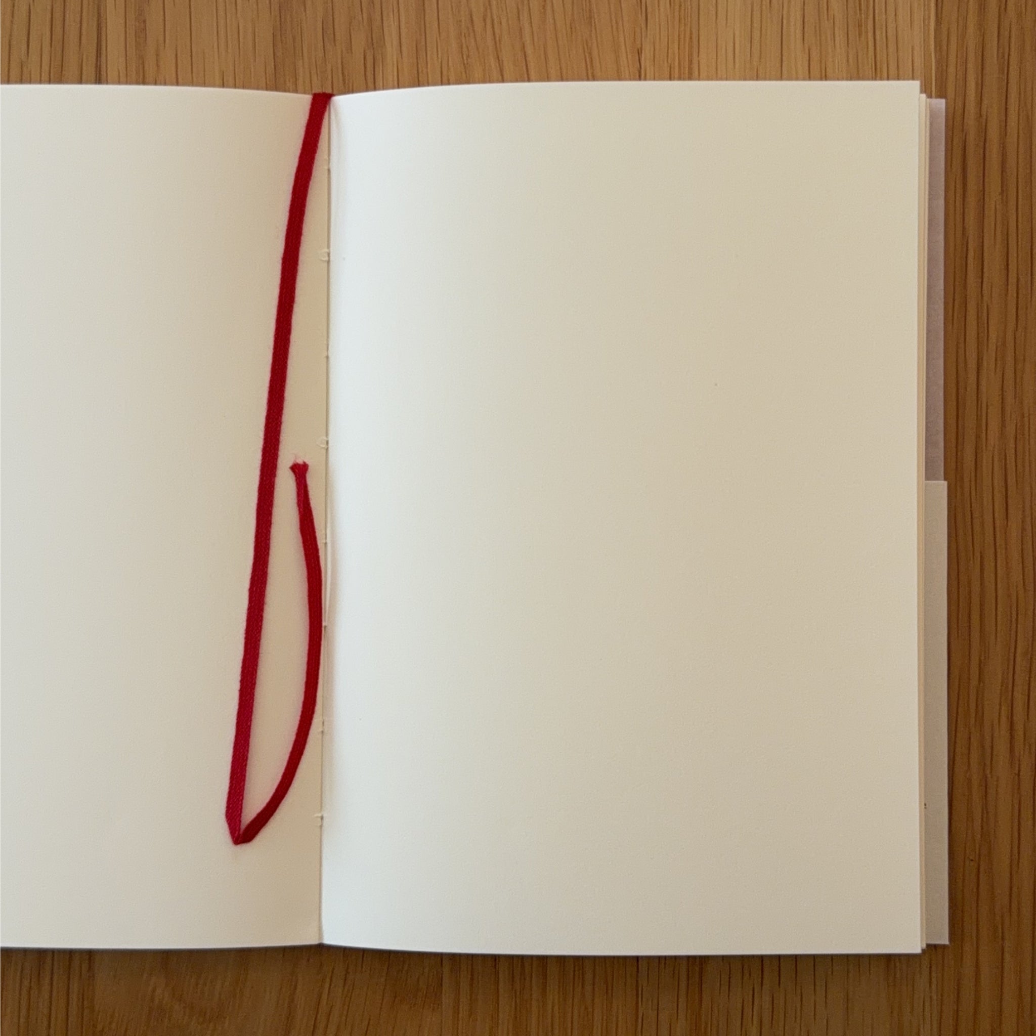 Midori MD Notebook A5 open to show the blank MD Paper and its bookmark string