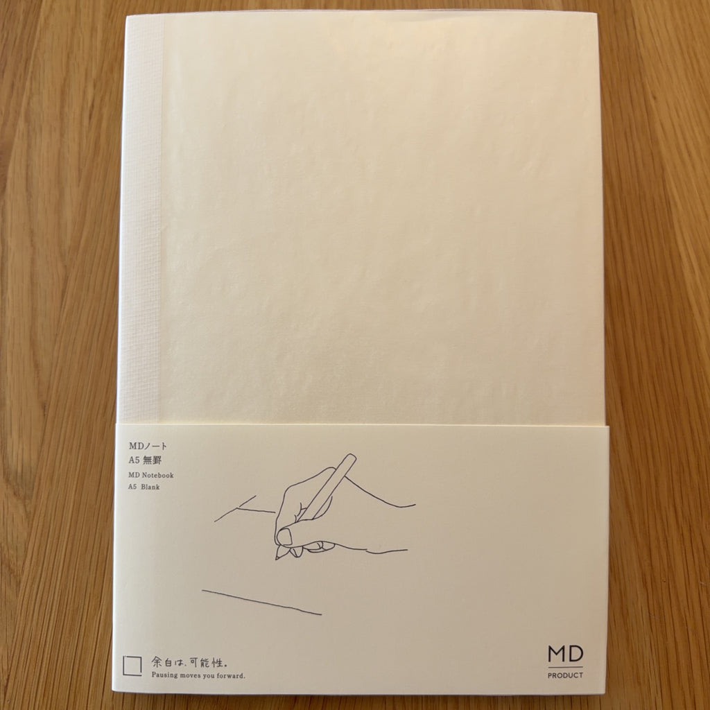 Midori MD Notebook A5 with glassine paper cover printed with a Blank ruling label and illustration