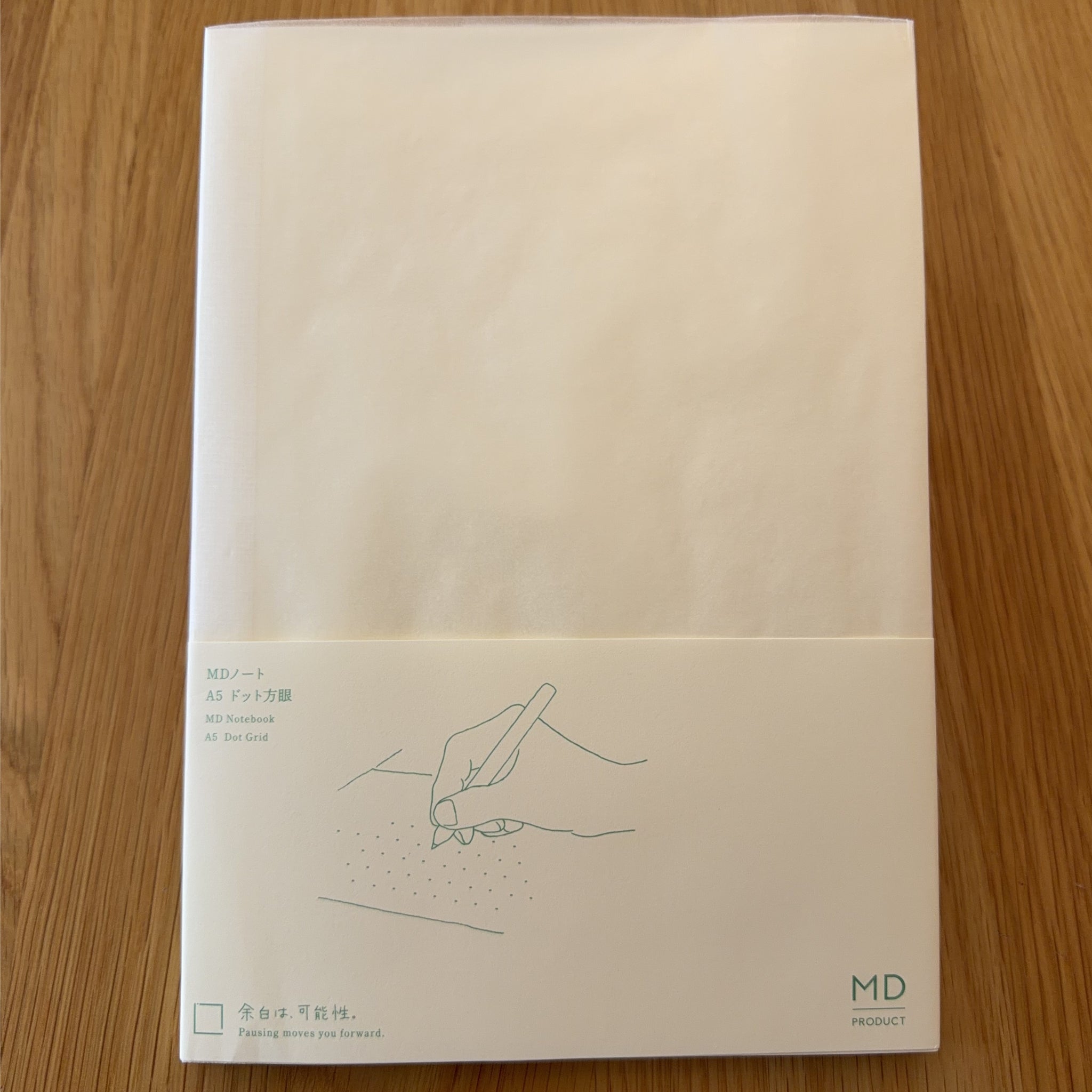 Midori MD Notebook A5 with glassine paper cover printed with a Dot Grid ruling label and illustration
