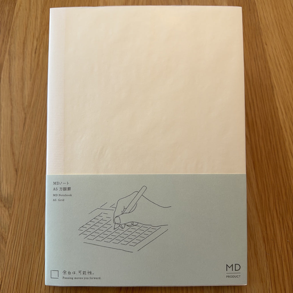Midori MD Notebook A5 with glassine paper cover printed with a Grid ruling label and illustration