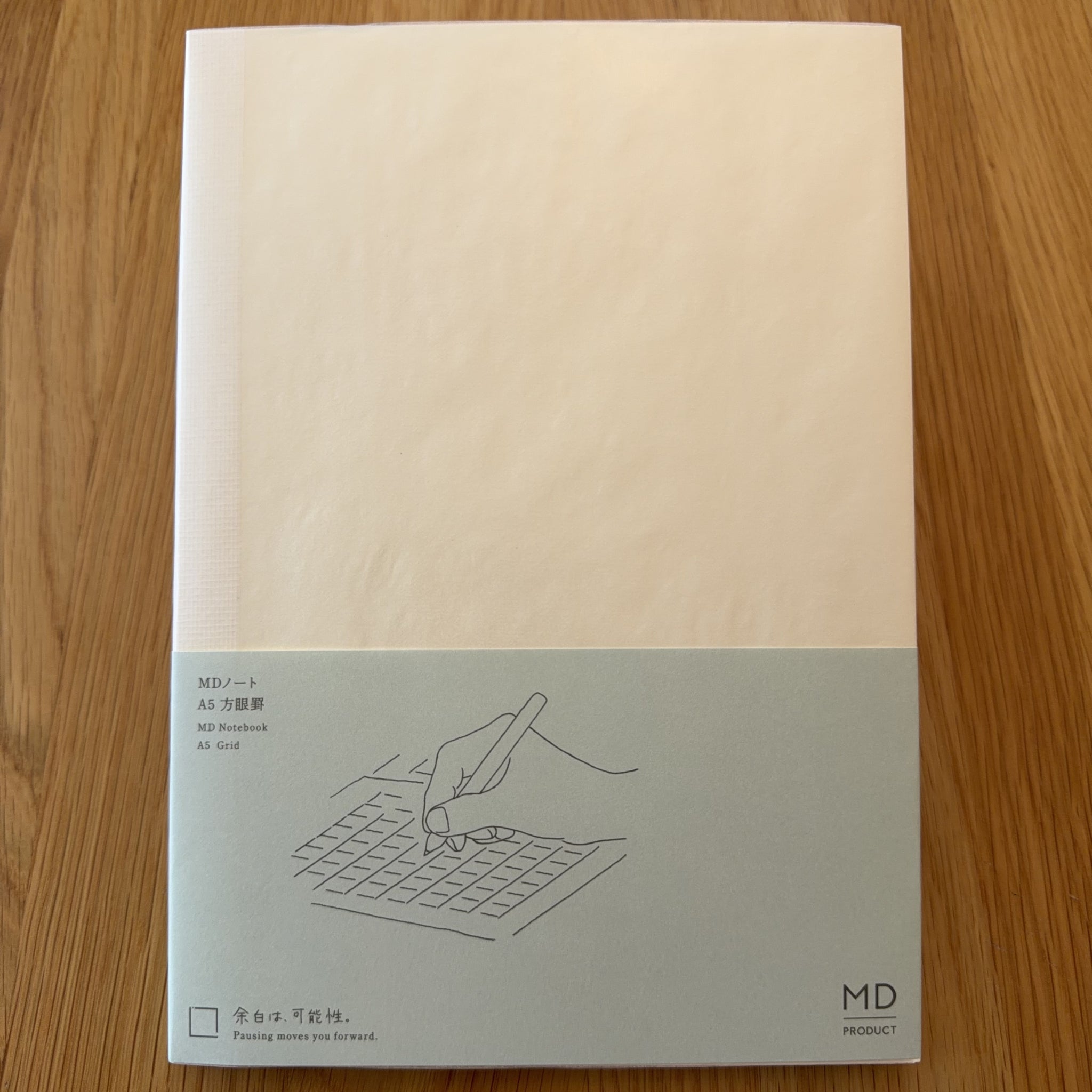 Midori MD Notebook A5 with glassine paper cover printed with a Grid ruling label and illustration