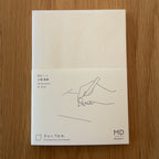 Midori MD Notebook A6 with glassine paper cover printed with a Blank ruling label and illustration