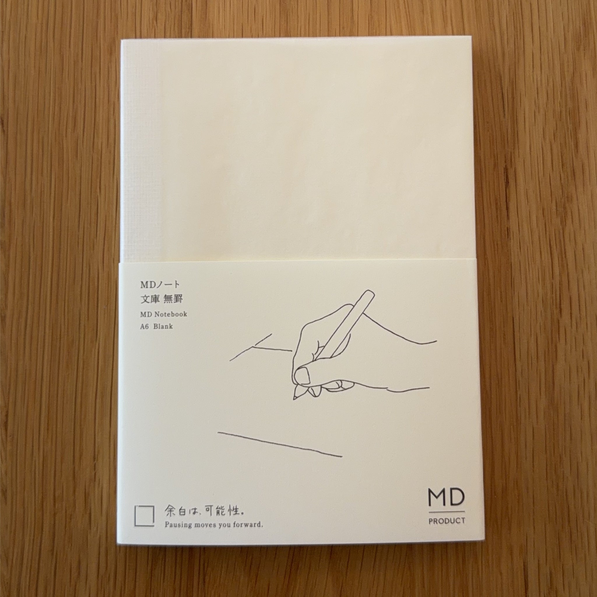 Midori MD Notebook A6 with glassine paper cover printed with a Blank ruling label and illustration