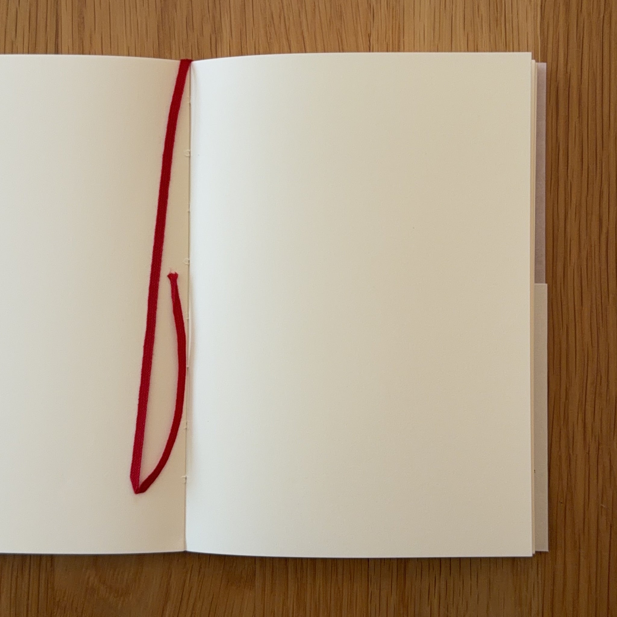 Midori MD Notebook A6 open to show the blank MD Paper and its bookmark string