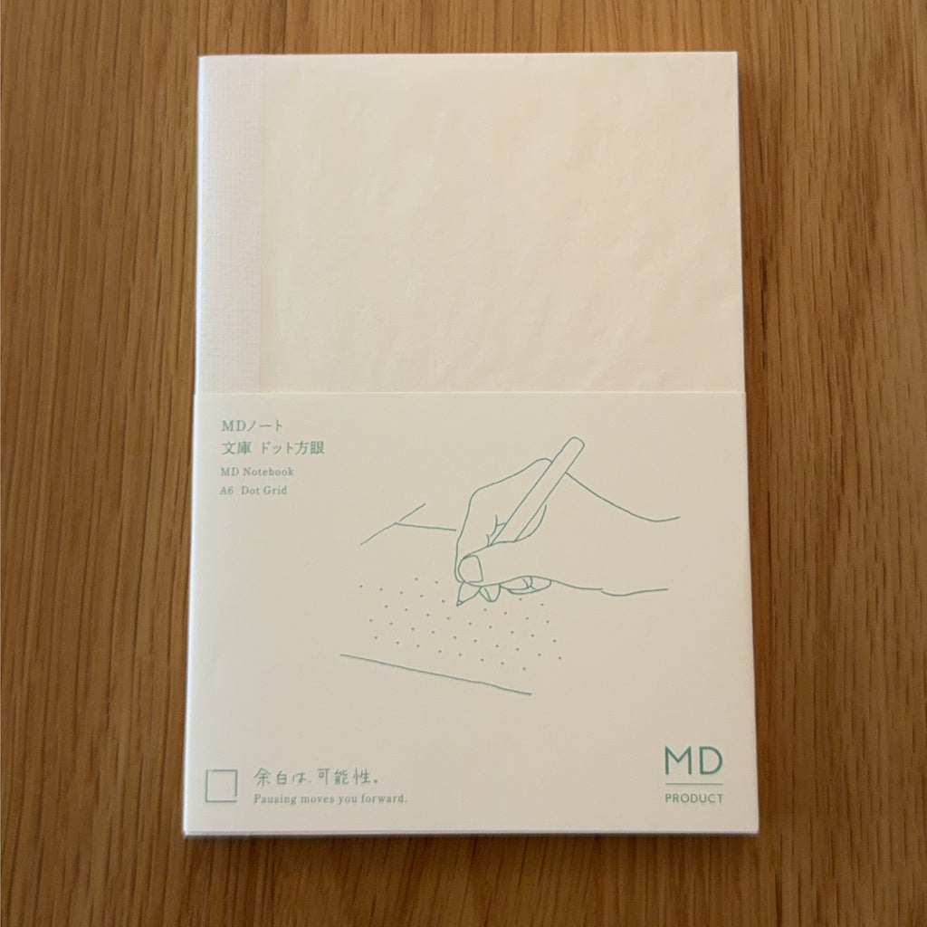 Midori MD Notebook A6 with glassine paper cover printed with a Dot Grid ruling label and illustration