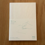 Midori MD Notebook A6 with glassine paper cover printed with a Dot Grid ruling label and illustration