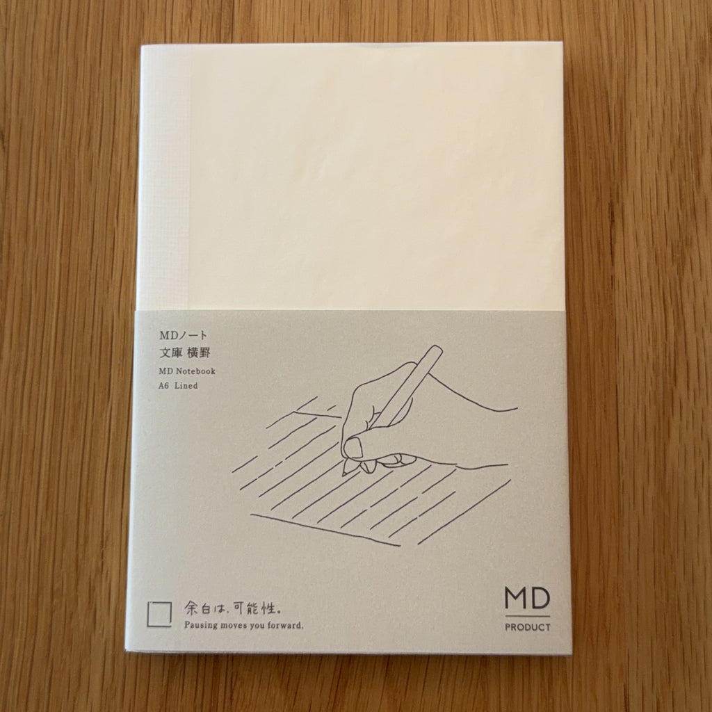 Midori MD Notebook A6 with glassine paper cover printed with a Lined ruling label and illustration