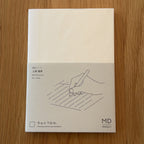 Midori MD Notebook A6 with glassine paper cover printed with a Lined ruling label and illustration