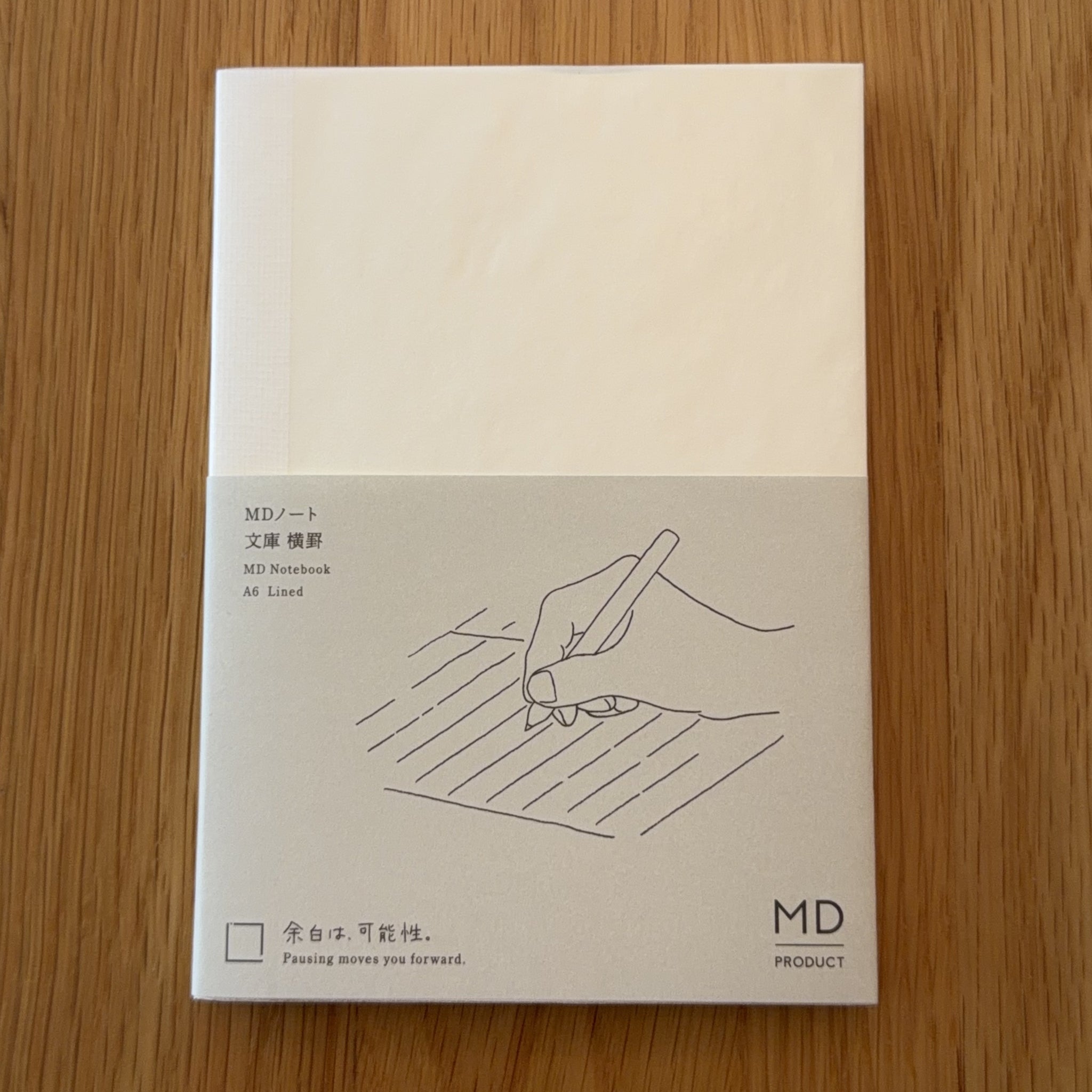 Midori MD Notebook A6 with glassine paper cover printed with a Lined ruling label and illustration