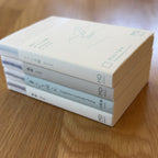 Stack of four Midori MD Notebook A7 ruling types — Blank, Lined, Grid, and Dot Grid