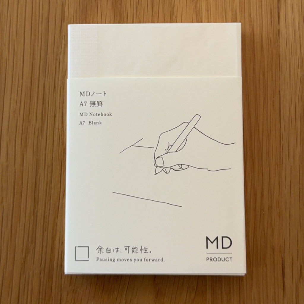 Midori MD Notebook A7 with glassine paper cover printed with a Blank ruling label and illustration