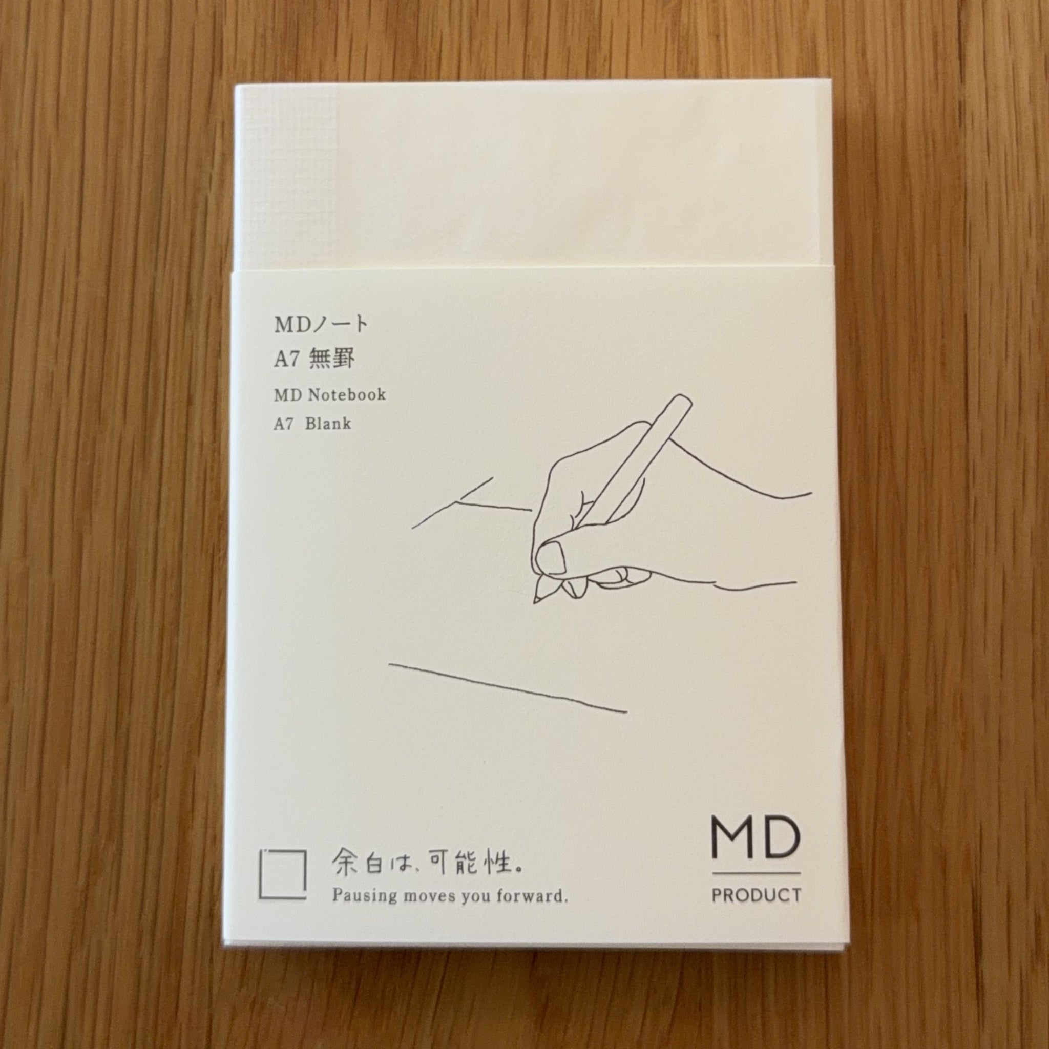Midori MD Notebook A7 with glassine paper cover printed with a Blank ruling label and illustration