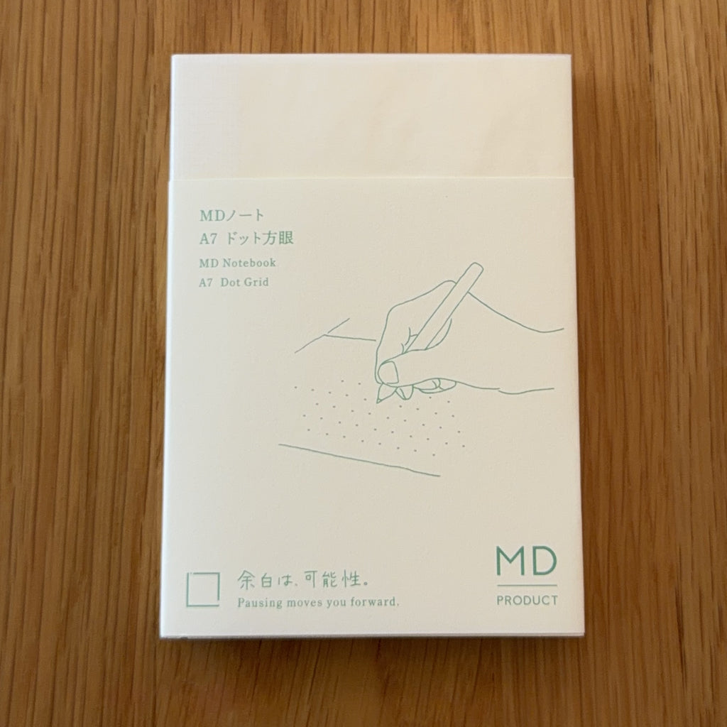 Midori MD Notebook A7 with glassine paper cover printed with a Dot Grid ruling label and illustration