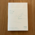 Midori MD Notebook A7 with glassine paper cover printed with a Dot Grid ruling label and illustration