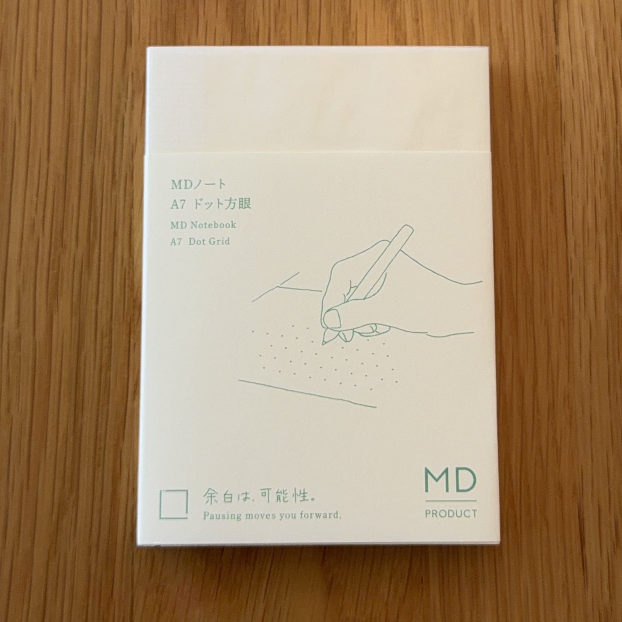 Midori MD Notebook A7 with glassine paper cover printed with a Dot Grid ruling label and illustration