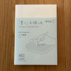 Midori MD Notebook A7 with glassine paper cover printed with a Grid ruling label and illustration
