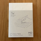 Midori MD Notebook A7 with glassine paper cover printed with a Lined ruling label and illustration